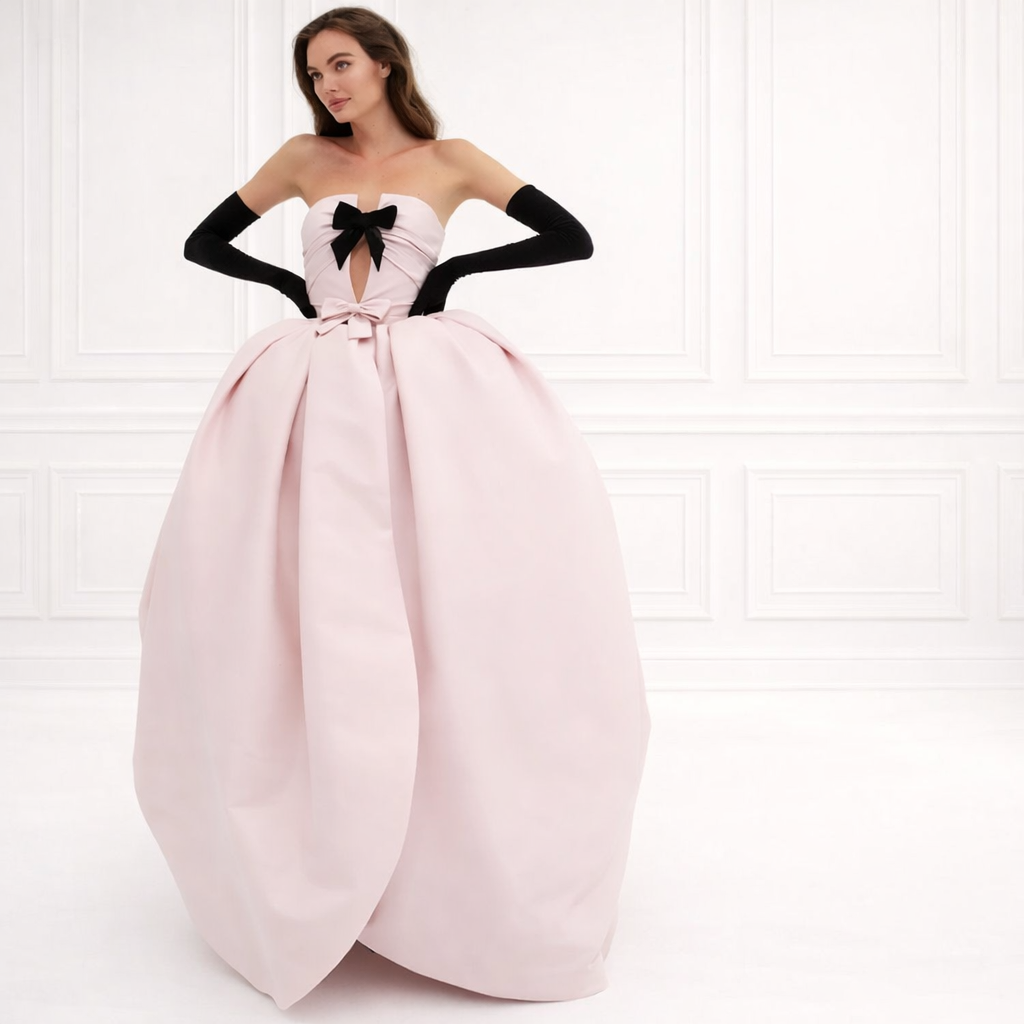Full front view of pink strapless ball gown with velvet bow