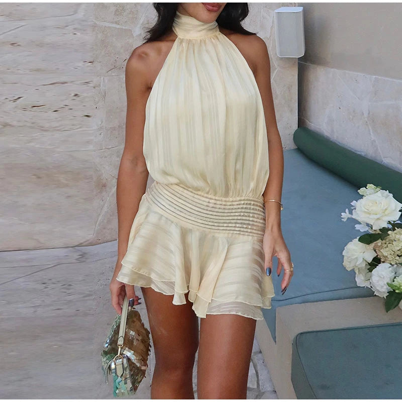 Model wearing casual high neck halter mini dress in cream