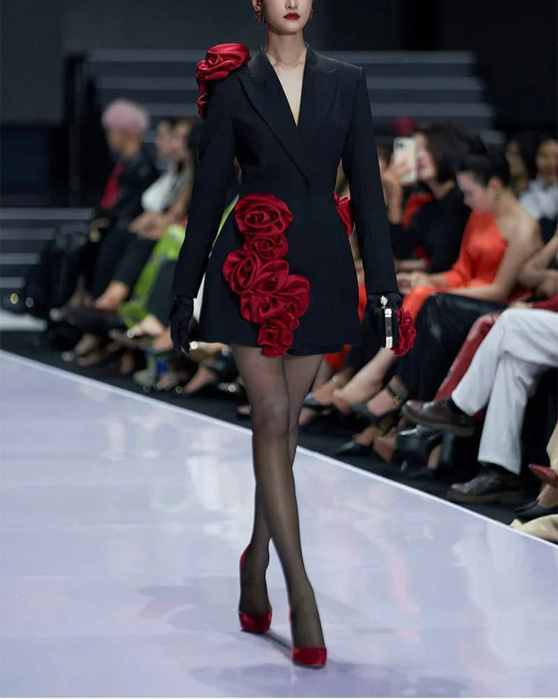 front view: "Model wearing womens black blazer dress with red flower details on runway