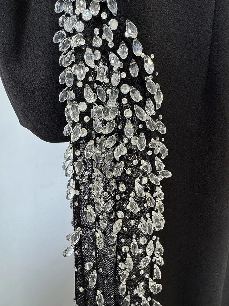 Intricate rhinestone beading detail on black maxi dress"