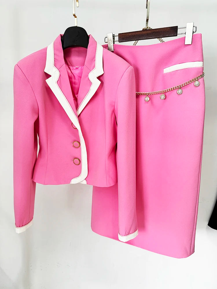 Women's pink blazer and midi skirt suit set displayed on hanger showing complete outfit