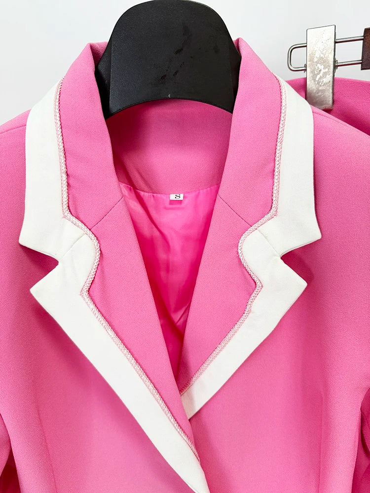Detail shot of turn-down collar and single breasted closure on pink blazer