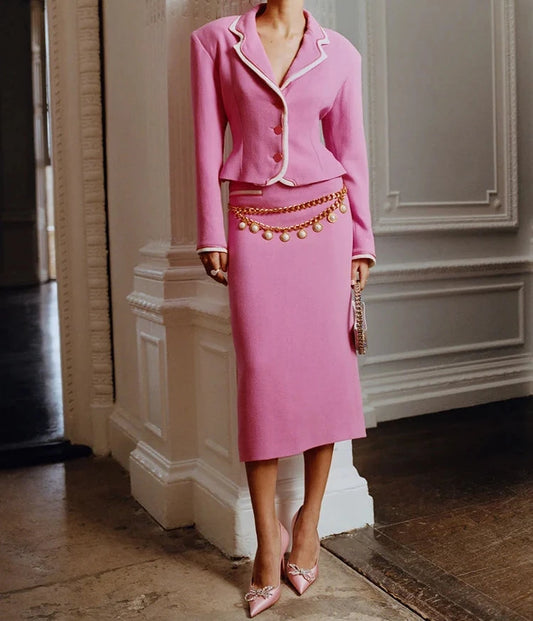 Model wearing women's pink blazer and midi skirt suit set with professional styling"