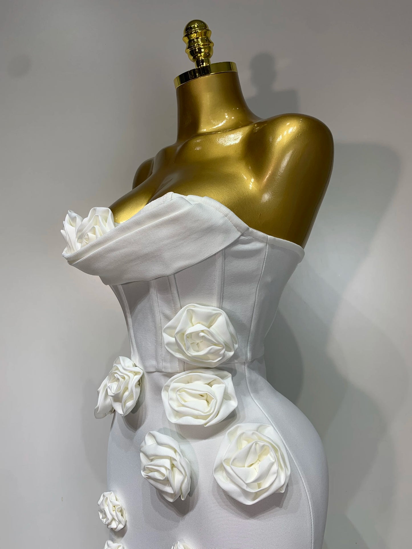 Close-up of flower appliqué details on strapless dress in white