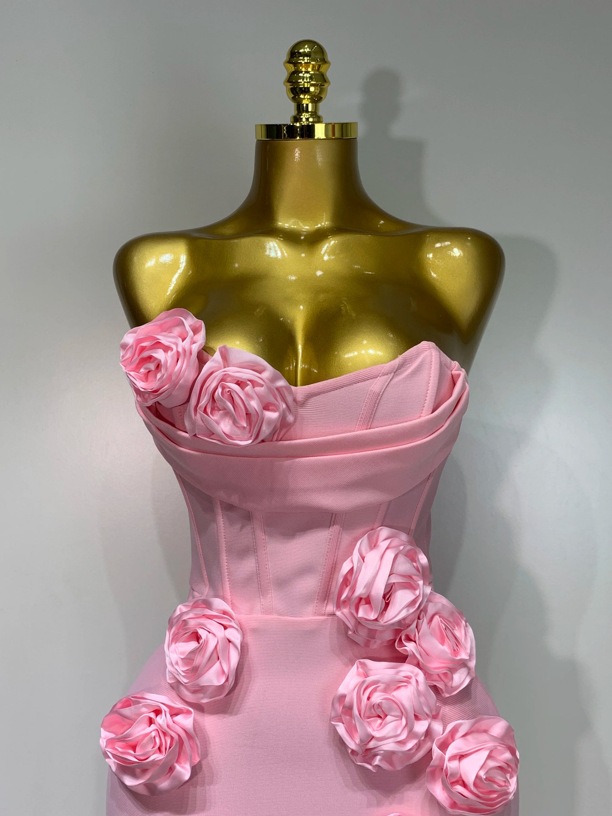 Close-up of flower appliqué details on strapless dress in pink